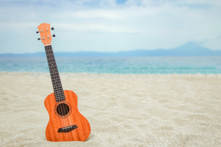 beautiful guitar on the sand by the Greek seaの写真素材