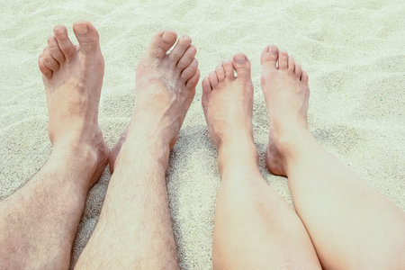 beautiful legs in the sand of the sea greece backgroundの写真素材