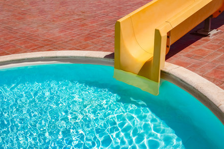 Step with slide in the pool by the sea nature background. For bathing turquoise water.