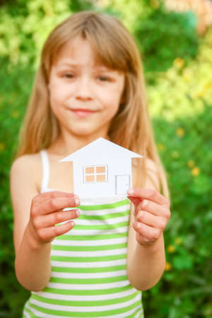 paper house in hands on a background of propertyの写真素材