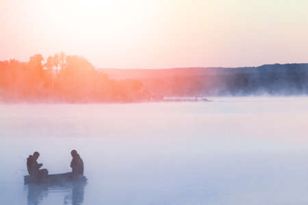 fisherman on the river in the fog in the park on the nature