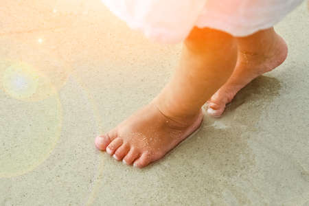 beautiful legs on the sand by the Greek seaの写真素材