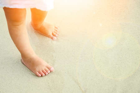 beautiful legs on the sand by the Greek seaの写真素材