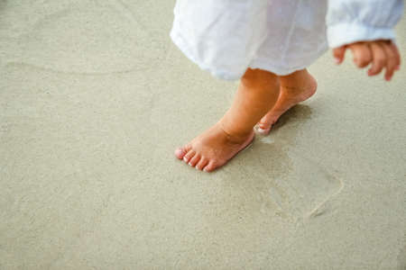 beautiful legs on the sand by the Greek seaの写真素材