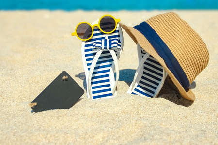 beautiful slippers in the sand of the sea in Greece background