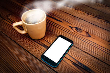 tasty coffee with phone on backgroundの写真素材