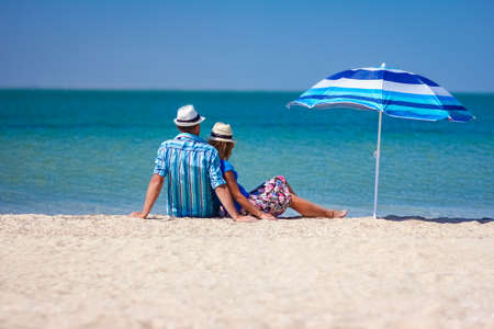 Happy couple guy with girl by the sea on nature travelの写真素材