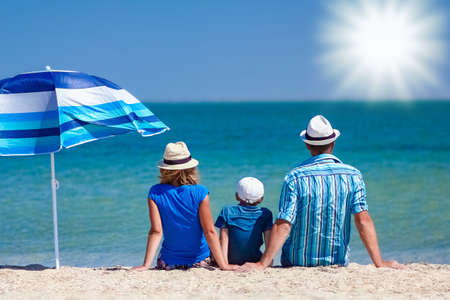 Happy family parents with children by the sea on nature travelの写真素材