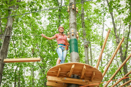 beautiful girl in the park on the ropes achieve Outdoors