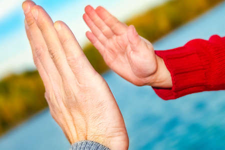 beautiful hands of parent and child by the sea