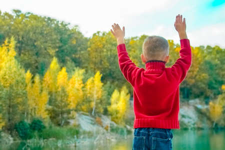 Happy child in nature in the park plays