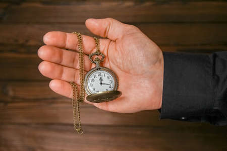 pocket watch in the hands of a manの写真素材