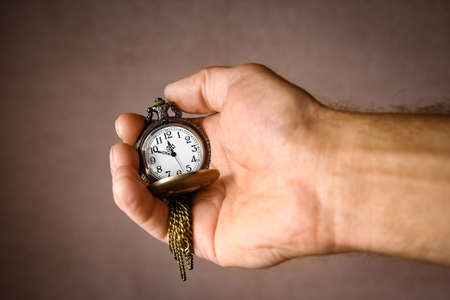 pocket watch in the hands of a manの写真素材