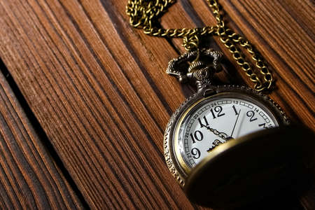 pocket watch on a wooden backgroundの写真素材