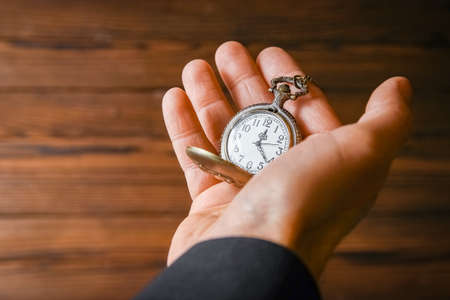 pocket watch in the hands of a man