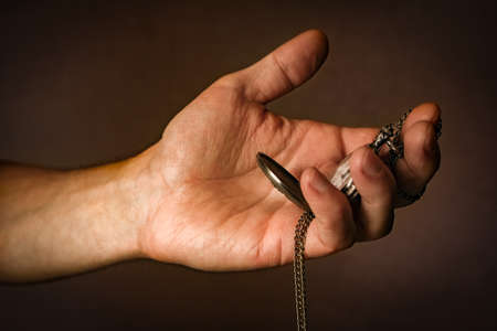 pocket watch in the hands of a manの写真素材