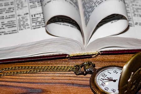 pocket watch with book backgroundの写真素材
