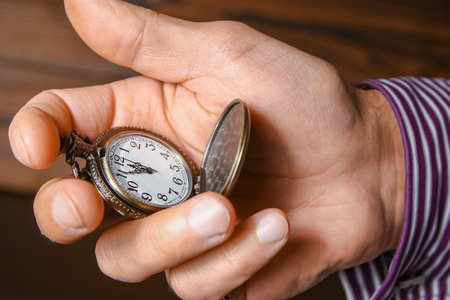 pocket watch in the hands of a manの写真素材