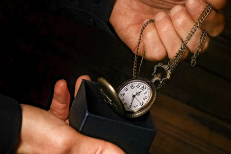 pocket watch in the hands of a manの写真素材