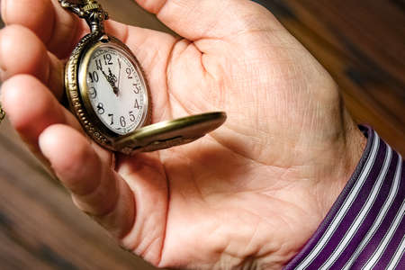 pocket watch in the hands of a manの写真素材