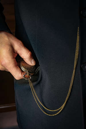 pocket watch in the hands of a manの写真素材