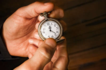pocket watch in the hands of a manの写真素材