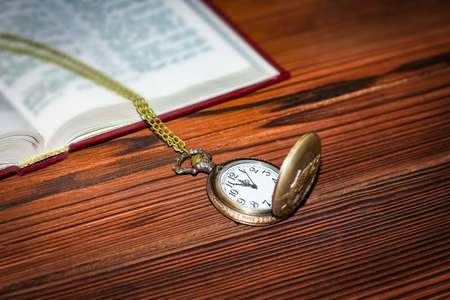 pocket watch with book backgroundの写真素材