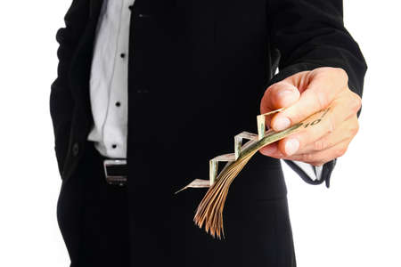 Business man holding money on white backgroundの写真素材