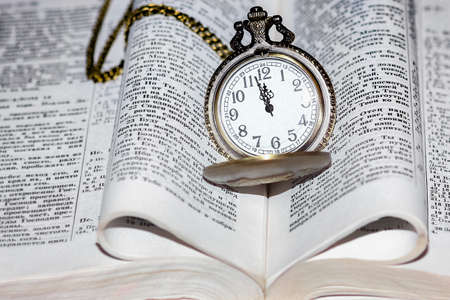 pocket watch with book backgroundの写真素材