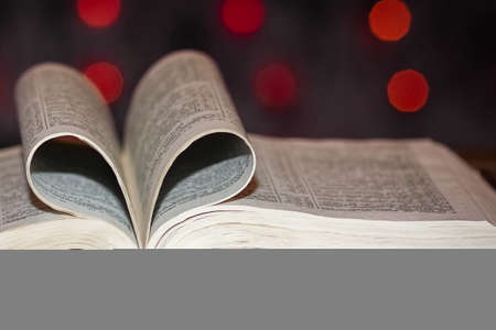 open book with heart on background