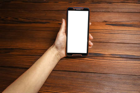 phone with hands addiction on a wooden background