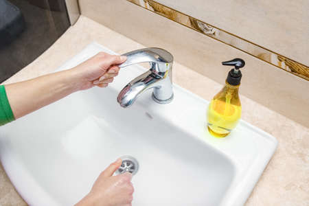Hands with soap are washed under the tap with water. Clean from infection and dirt and virus. At...