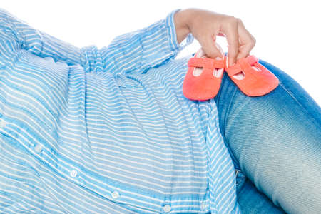 Happy pregnant girl lies on white background