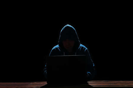 hacker with laptop on black backgroundの写真素材