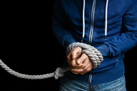 hands with a rope on a black background