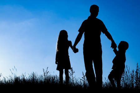 happy family outdoors in the park silhouetteの写真素材