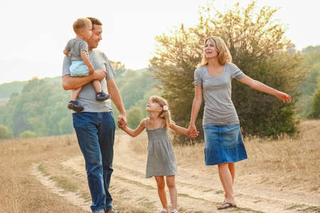 happy family on the nature of children rests with the road backgroundの写真素材
