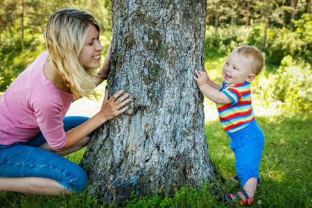 Happy parents with a child playing in a park on the natureの写真素材