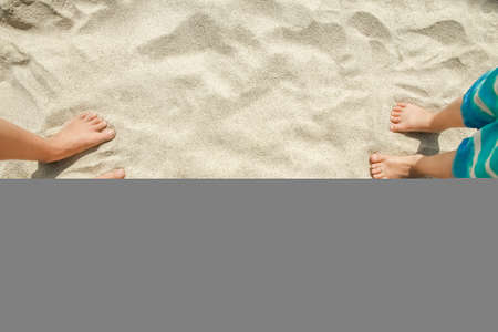 beautiful legs in the sand of the sea greece background