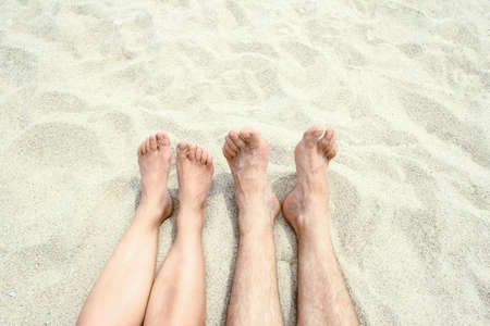 beautiful legs in the sand of the sea greece backgroundの写真素材