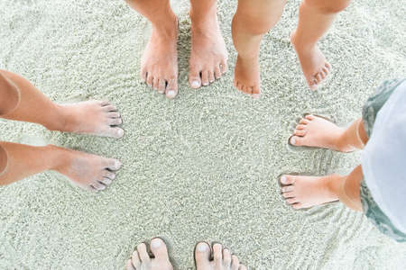 beautiful legs on the sand by the seaの写真素材
