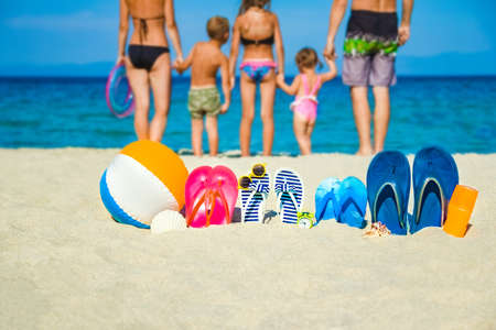 happy family on the sea with slippers on nature backgroundの写真素材