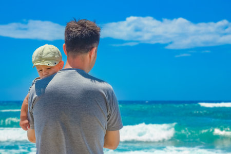 happy parent with a child by the sea in the open airの写真素材