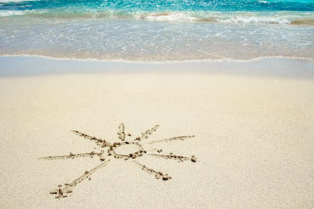 beautiful drawing on the sand near the sea shore background