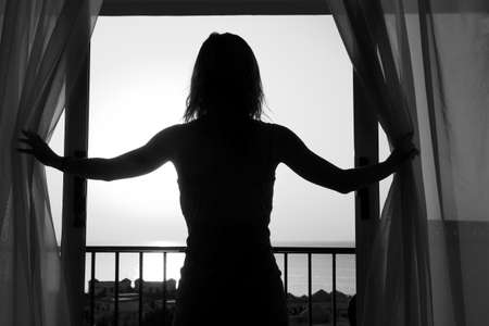 nice silhouette of a women near the window on hotelの写真素材