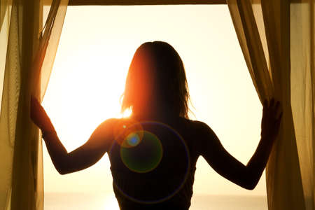 nice silhouette of a women near the window on hotelの写真素材