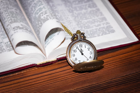 pocket watch with book backgroundの写真素材
