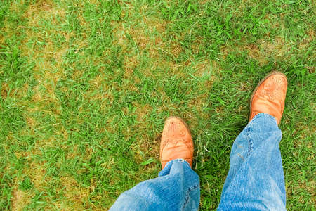 beautiful hands of a cowboy's legs in the park on natureの写真素材