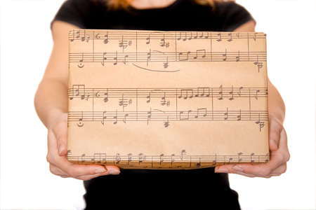 Beautiful gift in the hands of a girl on a white backgroundの写真素材