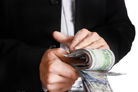 Business man holding money on white background